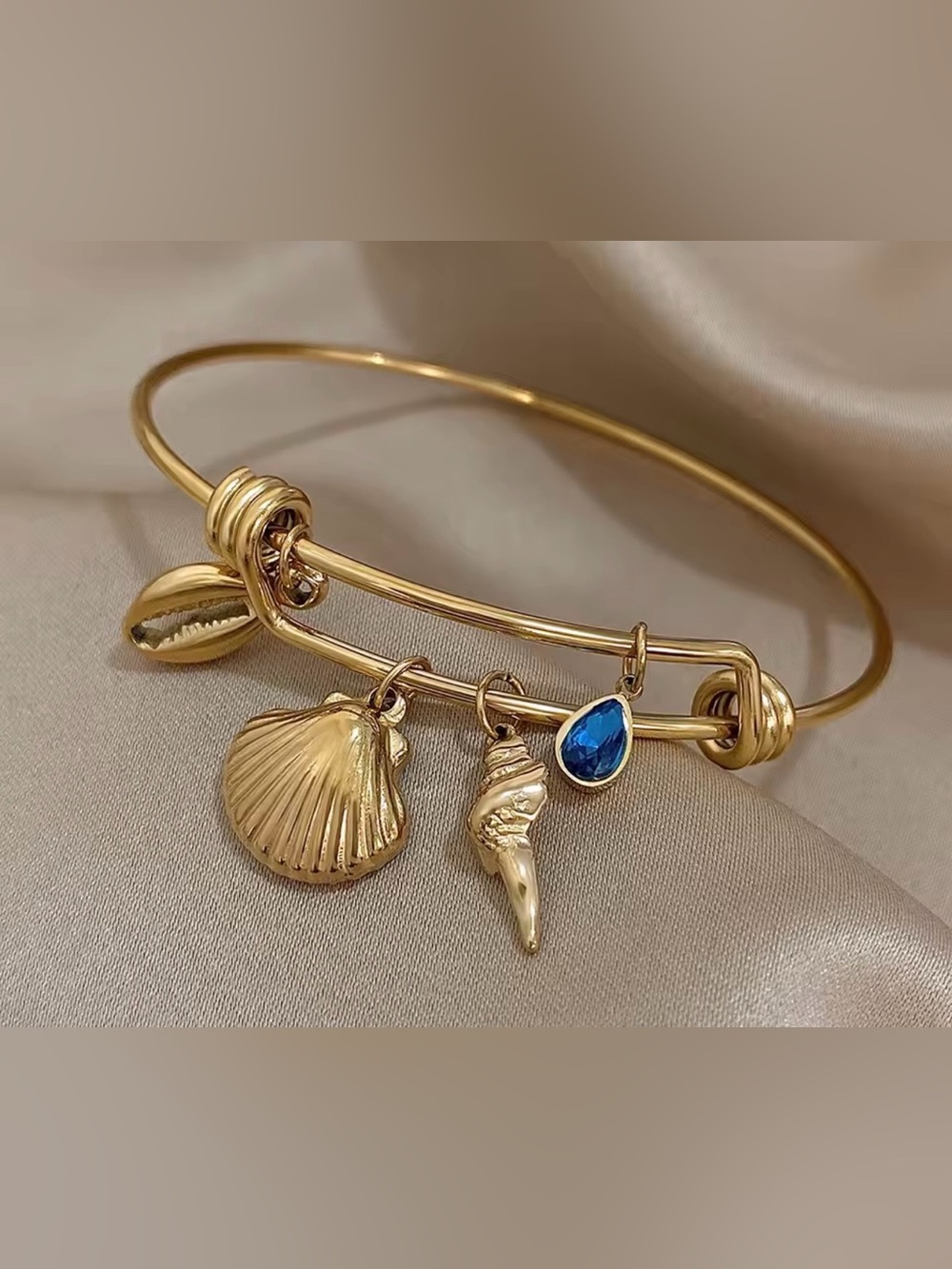 Gold Seashell Charm Bangle Bracelet with Blue Teardrop Stone
